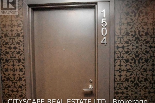 Close-up of a metal apartment door with the number 1504 in silver, set against patterned wallpaper. - 1504 - 197 Yonge Street, Toronto