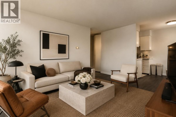 Living room with sectional sofa, television, and doorway to bathroom. - 1505 1251 Cardero Street, Vancouver