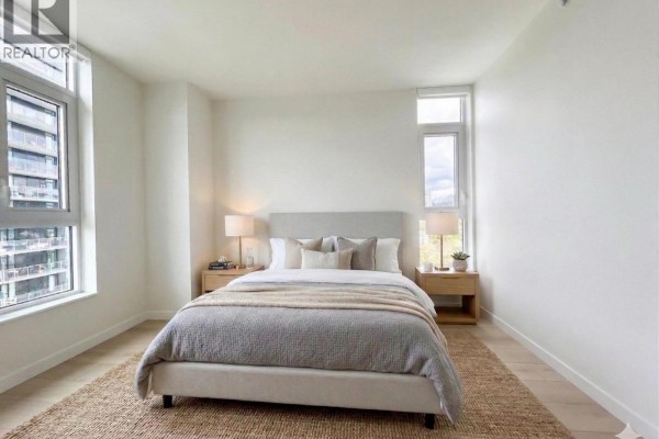 Spacious room with natural light, hardwood flooring, and balcony access - 1506 311 Alderson Avenue, Coquitlam