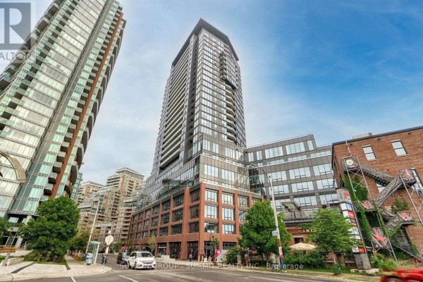 Exterior view of a modern high-rise apartment building on a city street. - 1507 - 135 East Liberty Street, Toronto