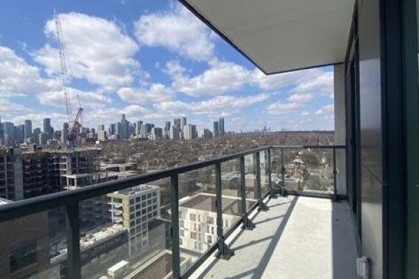 View from the balcony showing Toronto skyline with buildings and construction cranes under a cloudy sky. - 1508 - 130 River Street, Toronto