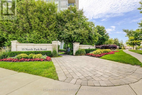 Stone entryway with landscaped flower beds and signage for 15 North Park Road. - 1509 - 15 North Park Road, Vaughan
