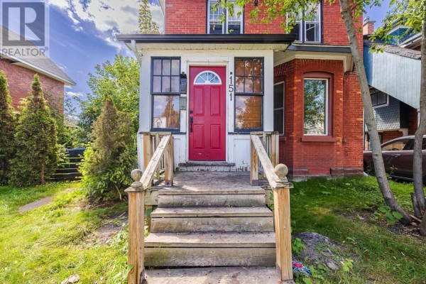 Close-up of the wooden porch steps and red front door of a brick house. - 151 Albert St E, Sault Ste  Marie