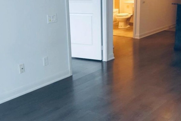 Hallway with dark wood floors and doors to a bedroom and bathroom. - 1511 - 5162 Yonge Street, Toronto