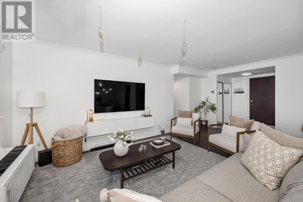 Common area featuring leather seating, wooden flooring, and large windows for natural light. - 1512 - 2760 Carousel Crescent, Ottawa