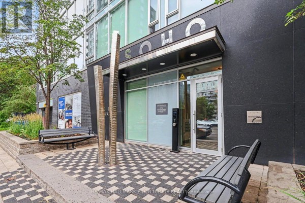 Entrance to the SOHO building with a modern canopy, benches, and metal sculptures. - 1512 - 300 Lisgar Street, Ottawa