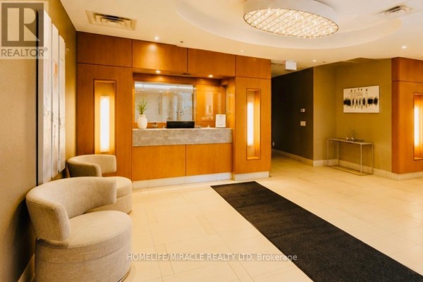 Gym with treadmills, weight machines, free weights, and mirrored walls under fluorescent lighting. - 1512 - 840 Queens Plate Drive, Toronto