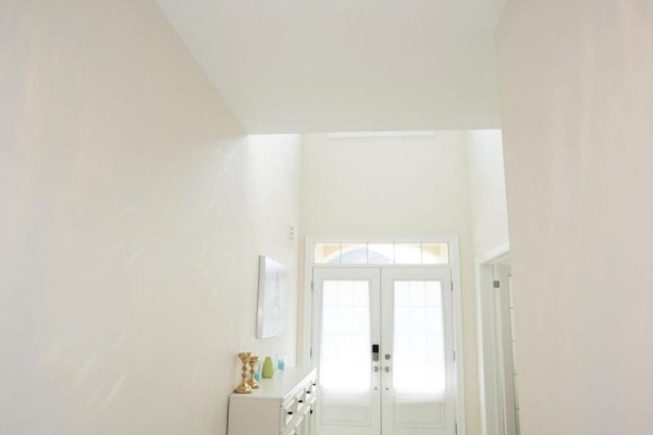 Bright hallway with high ceilings, modern light fixtures, and artwork featuring the Eiffel Tower. - 152 Ben Sinclair Avenue, East Gwillimbury
