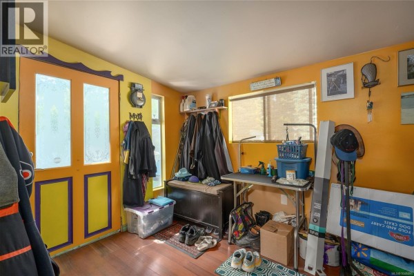 View from inside a room looking out onto a wooden deck with stained glass. - 1520 Mason Trail, Parksville