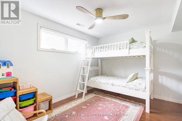 Child's bedroom with bunk bed, toy storage, ceiling fan, and window - 1520 Rosemount Road Tay