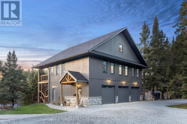 Rear exterior of the house featuring a multi-level deck with outdoor seating and patio below. - 1520 Rosemount Road, Tay