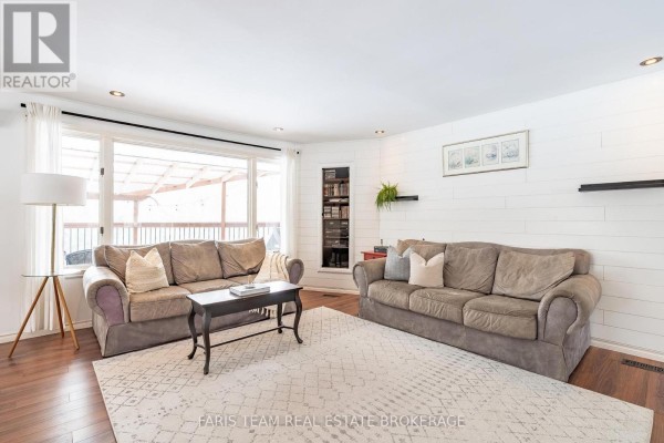 Living room with two sofas, coffee table, and large window - 1520 Rosemount Road Tay