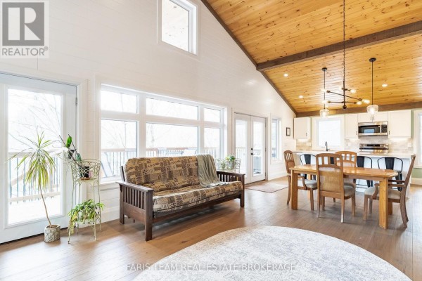 Living room with sofa, dining table, and kitchen island - 1520 Rosemount Road Tay