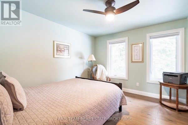 Bedroom with a bed, ceiling fan, and windows - 1520 Rosemount Road Tay