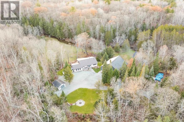 Two homes, garage, deck, fire pit, solar panels on wooded lot with creek - 1520 Rosemount Road Tay