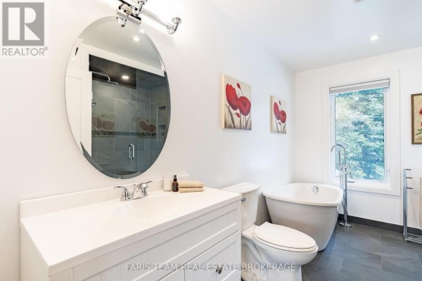 Modern bathroom with freestanding tub, walk-in shower, and double vanity - 1520 Rosemount Road Tay
