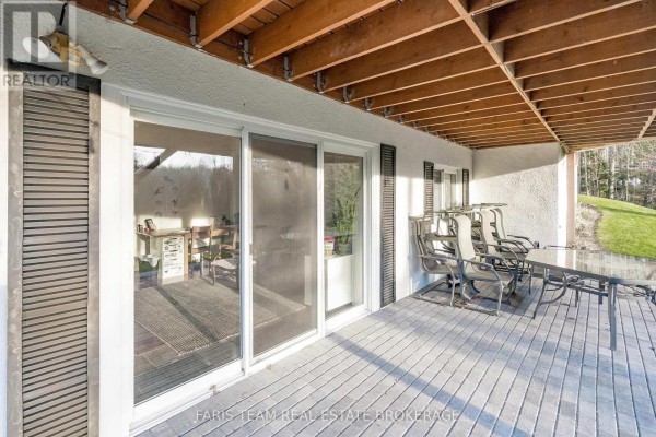 Covered deck with sliding glass doors, patio furniture, and outdoor lighting - 1520 Rosemount Road Tay
