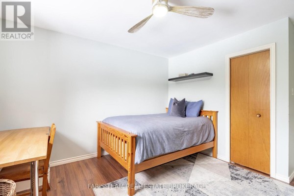 Bedroom with bed, desk, and ceiling fan - 1520 Rosemount Road Tay