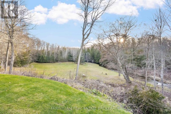 Grassy yard with creek and trees - 1520 Rosemount Road Tay