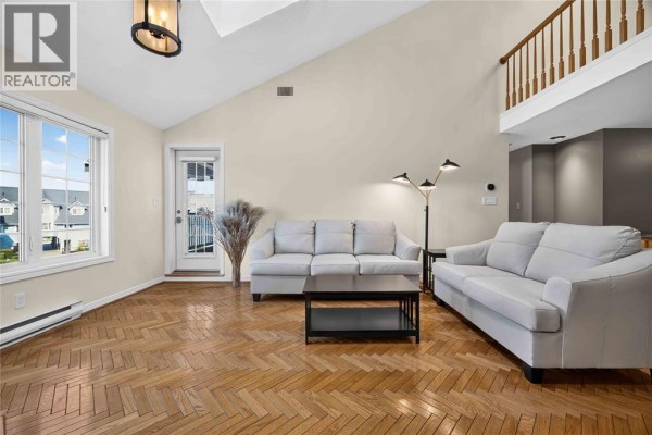 Living room with two sofas, parquet flooring, a fireplace, and a view of the marina. - 1520 Venetian Boulevard Unit# M-306, Point Edward