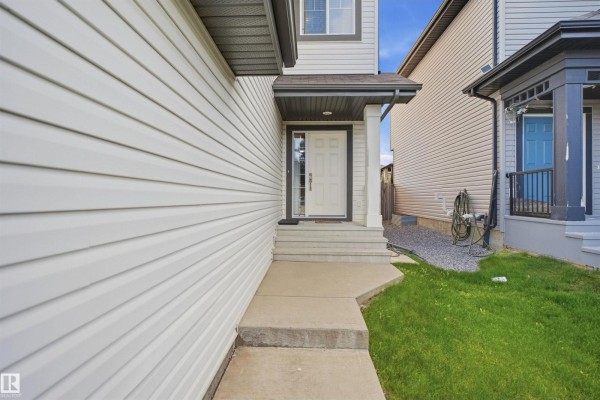 Primary bathroom with a double vanity, large mirror, and corner jacuzzi tub. - 1523 36 Av Nw, Edmonton