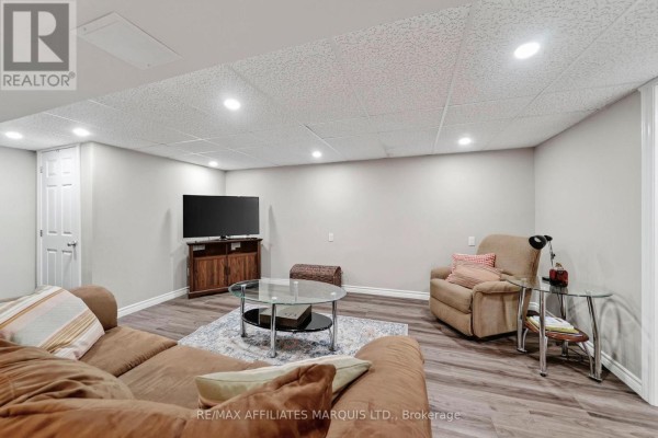 Finished basement living room with sectional sofa, recliner, TV, and coffee table - 15253 County Road 2 Road South Stormont