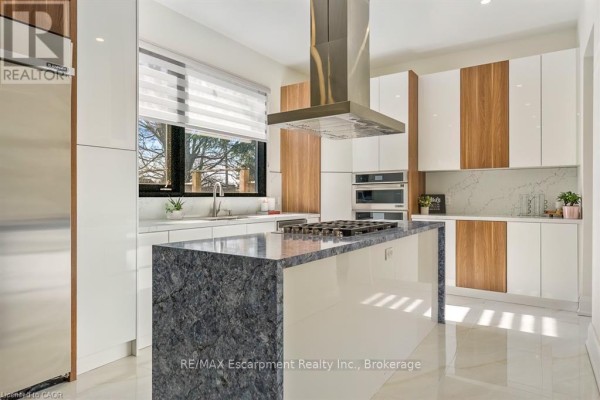 Modern bathroom vanity, toilet, and glass shower with marble tile - 1526 Bridge Road Oakville