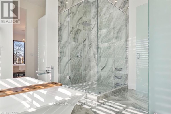 Modern kitchen with island, double ovens, gas stovetop, and double sink - 1526 Bridge Road Oakville