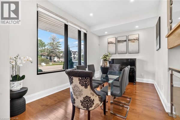 Modern two-story house exterior with a white stucco facade, wood accents, and a double garage. - 1526 Bridge Road, Oakville