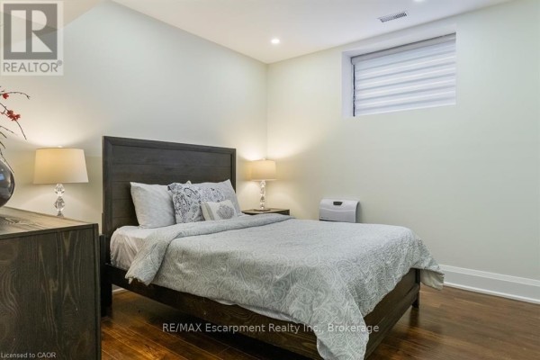 Modern bathroom with glass shower, dual flush toilet, and wood vanity - 1526 Bridge Road Oakville