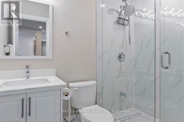 Kitchen with stainless steel appliances and modern cabinetry - 1526 Bridge Road Oakville