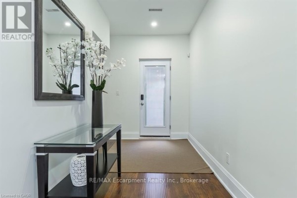 Glass dining table with upholstered chairs, console table, and mirror - 1526 Bridge Road Oakville