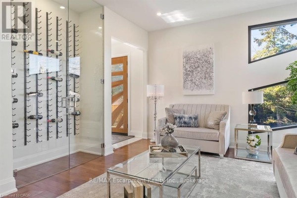 Dining room with glass table and modern staircase - 1526 Bridge Road Oakville