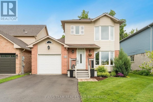 Front exterior of a beige and brick house with a two-car driveway. - 153 Cardinal Street, Barrie