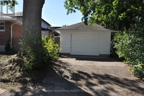 Detached white garage with a white rolling door on a paved driveway. - 153 Langarth Street W, London South