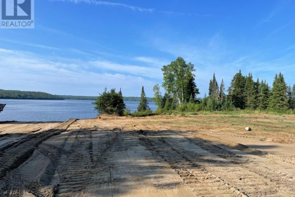 Expansive view of a lake and trees from a dirt lot with vehicle tracks. - 153 Rudolph Road, Thunder Bay Remote Area