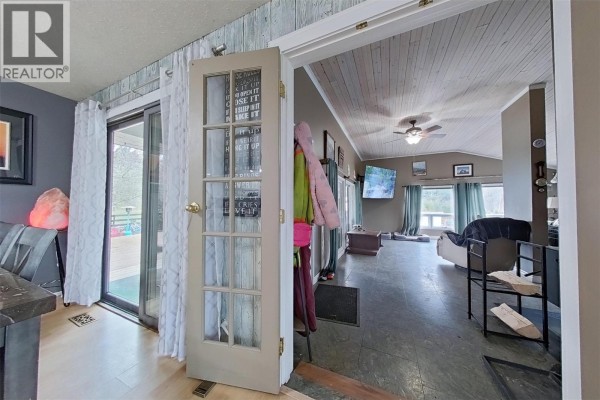 Entryway with French doors leading to the living area and views of the deck - 1530 21 Highway, Creston