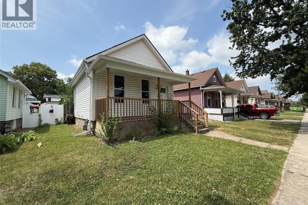 View of the house from the side, showing the street and neighboring houses. - 1539 Windermere Road, Windsor