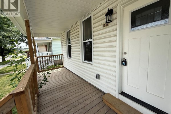 Close-up of the front door and porch of the house, showing siding and windows. - 1539 Windermere Road, Windsor