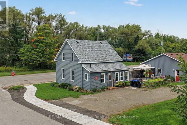 Grey house with detached garage and patio - 154 Robert Street W Penetanguishene