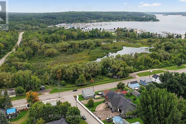 Aerial view of waterfront property with marina, pond, and houses - 154 Robert Street W Penetanguishene