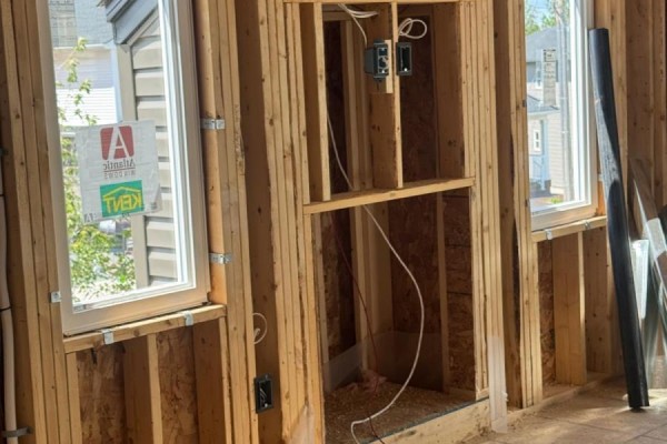 Close-up of interior framing with electrical wiring, windows, and a framed space for a fireplace. - 154 Terrastone Ridge, Dartmouth