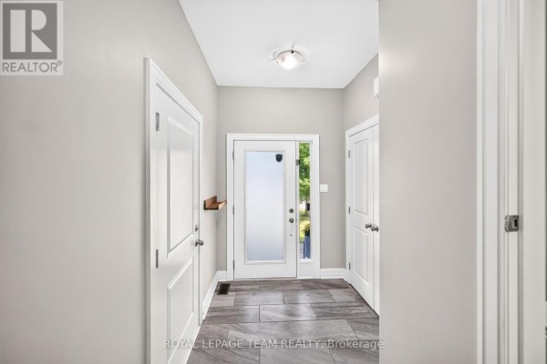 Carpeted hallway at the top of stairs with a dark wood railing and doors leading to rooms. - 154 Woodhurst Crescent, Ottawa