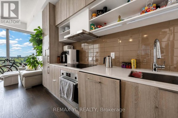 Modern kitchen with light wood cabinetry, white quartz countertops, and stainless steel appliances. - 1540 - 8 Hillsdale Avenue E, Toronto