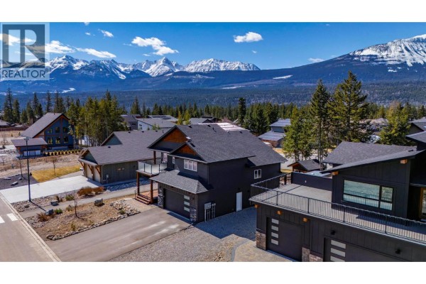 Aerial view of a modern home with a dark facade, garage, and balcony. - 1542 Cedar Street, Golden
