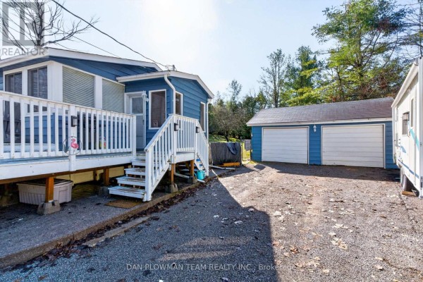 Aerial view of the property with a blue house, garage, and a large blue lake. - 1545 Westview Crescent, Selwyn