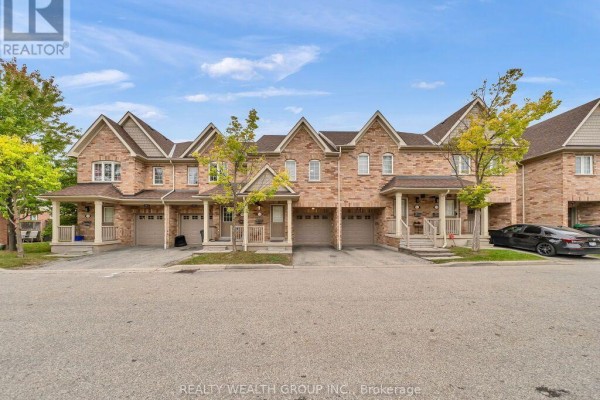 Front exterior view of a row of brick townhouses with garages and driveways. - 155 - 5255 Palmetto Place, Mississauga