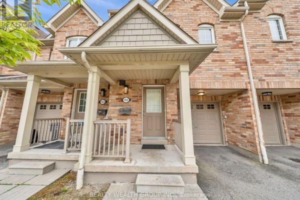 Close-up of townhouse entrance at 155 Palmetto Place with covered porch and garage. - 155 - 5255 Palmetto Place, Mississauga