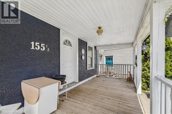 Close-up of the covered front porch with white railings and a white front door. - 155 1/2 Lake Street, St  Catharines