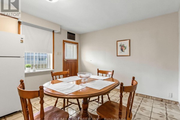 Wooden dining table and chairs, refrigerator, and tiled floor - 155 Ascot Avenue Toronto